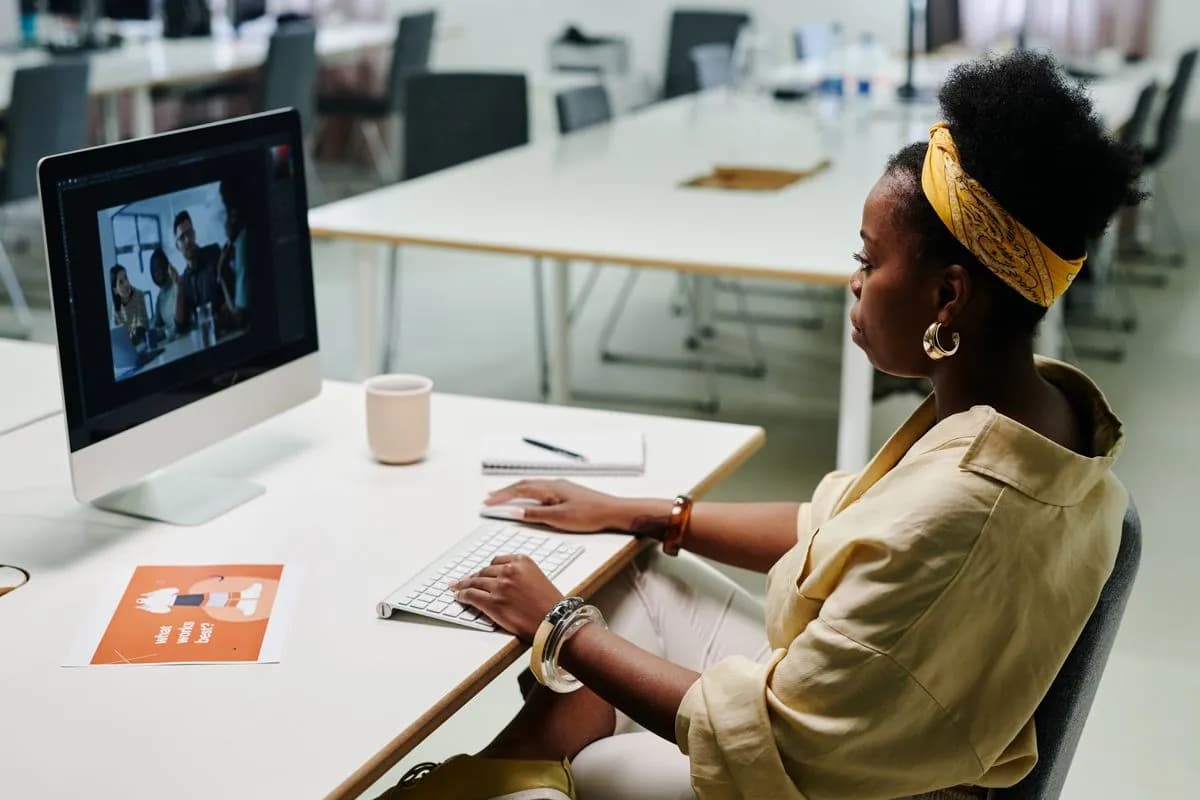 A designer editing an image on a desktop computer